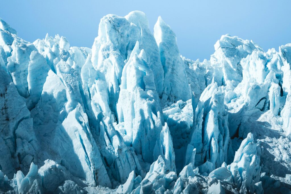 Stunning view of towering iceberg formations under clear blue skies, capturing the essence of winter.
